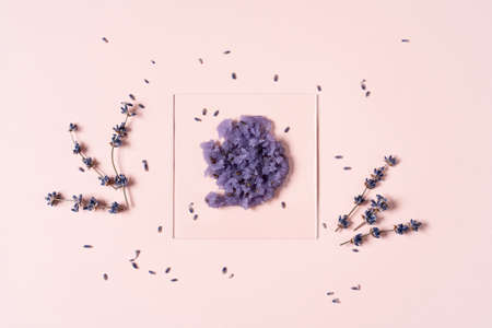 Beautiful smear of lavender scrub on a glass on a pastel beige background. Cosmetics laboratory research concept.の素材 [FY310183689844]