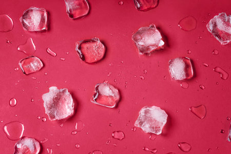 Melting ice cubes on trendy viva magenta background. Frozen water in the form of cubes. beautiful...