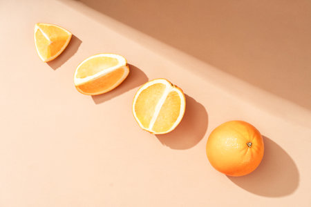 Fruity oranges on a beige background. orange pattern. Beautiful background from natural materialsの写真素材