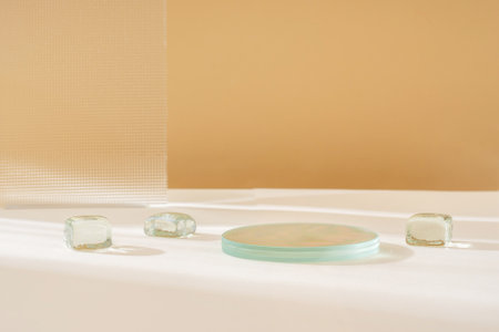 Composition empty podium material glass and metal geometric shape. Pastel beige background. Beautiful background made of natural materials for product presentationの写真素材