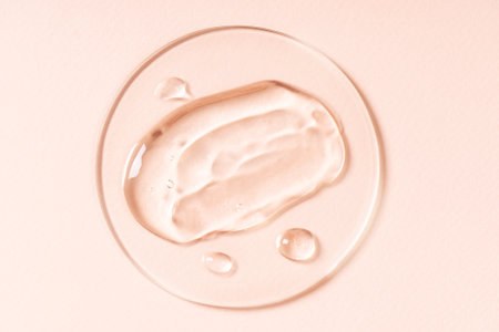 Drops and smears of cosmetics. Drops of liquid transparent gel with bubbles on a brown backgroundの写真素材