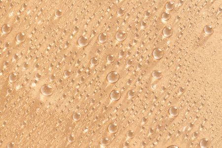 Abstract cosmetic background of a drop of moisturizing liquid on a pink background. Moisturizer...