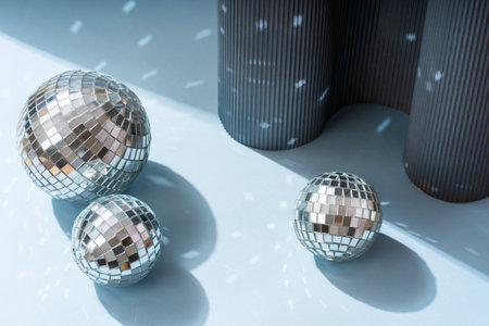 Disco ball on a blue background with shadows and highlights of bright sunlight. Abstract holiday...