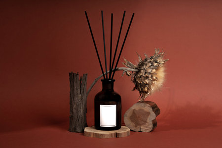 Beautiful diffuser bottle in brown glass jar on wood texture. Home decor, aromatherapy rest relaxation meditation.の写真素材
