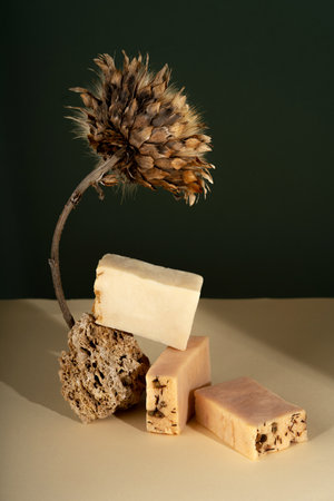 Pattern natural handmade soap of different sizes and colors. Brown background shadows of flowers from the sun. Cosmetic pedestal for product promotionの写真素材