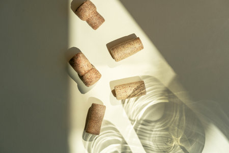 Different glasses for wine, cocktails, drinks, long sun shadow on a light beige background. The concept of wine tasting or summer vacationの写真素材