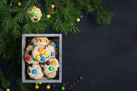 Christmas card. Space for text. Christmas tree on a black wooden background with sweets and biscuits. The original idea of ??Christmas. New Year. top view blank space for text Christmas. Copy Space.の写真素材