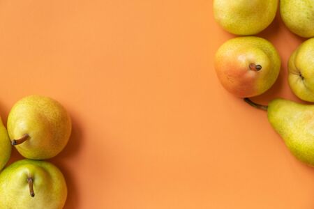 fresh pears on an orange backgroundの写真素材