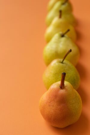 fresh pears on an orange backgroundの写真素材