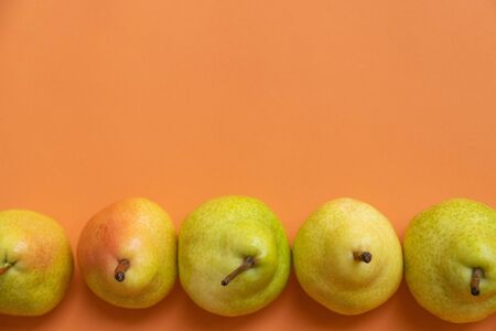 fresh pears on an orange backgroundの写真素材