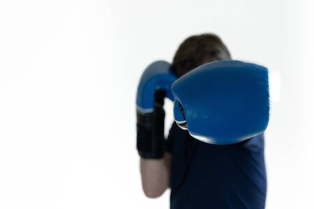 a man with blue Boxing gloves throws a jabの写真素材