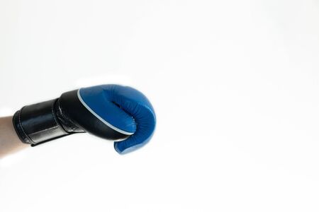hand in a blue Boxing glove on a white backgroundの写真素材