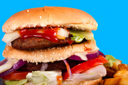 Hamburger with fries isolated on blue backgroundの写真素材