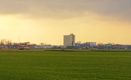 Rural landscape with agricultural silo against dramatic skyの写真素材
