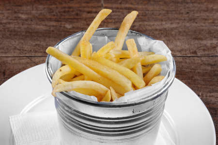 Delicious french fries closeup on the tableの写真素材