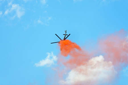 Helicopter in the air against blue skyの写真素材