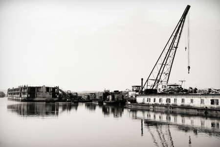 Damaged industrial boats at the bay outdoorsの写真素材