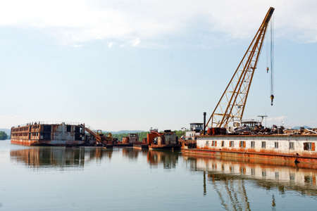 Damaged industrial boats at the bay outdoorsの写真素材