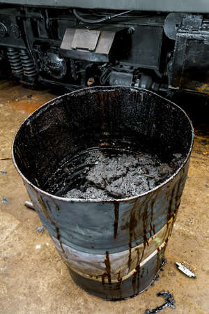 Damaged oil drums in industrial interior closeupの写真素材