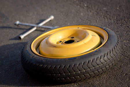 Spare wheel of a car with toolの写真素材