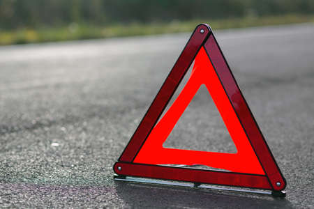 Red triangle of a car on the roadの写真素材