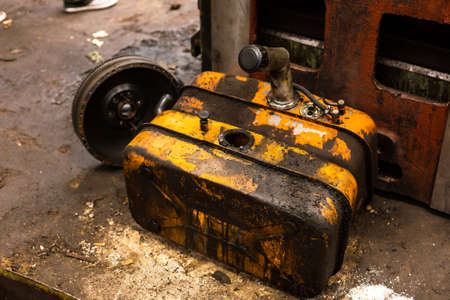 Damaged oil drums in industrial interiorの写真素材
