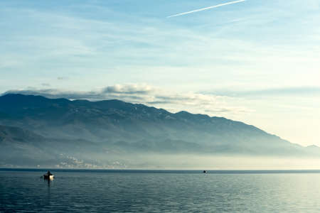 Boats at sunset with blue seaの写真素材