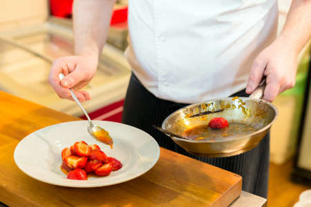 Human hands  cooking fruits in kitchen closeupの写真素材