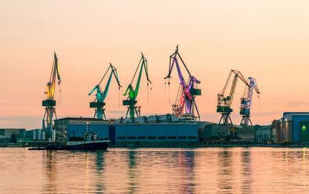 Port warehouse with cargoes and containers at nightの写真素材