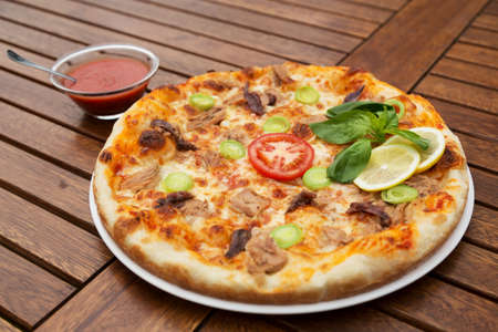 Delicious italian pizza served on wooden table closeupの写真素材