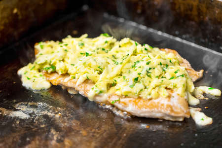 cooking meat in a frying pan closeupの写真素材