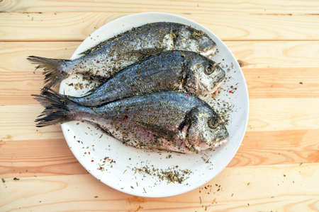Fish on white plate background closeupの写真素材