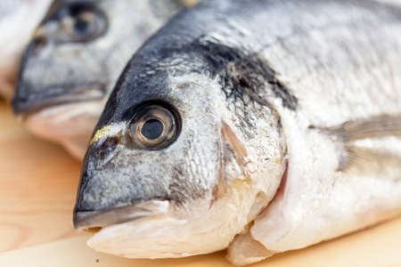 Fish on wooden background closeupの写真素材