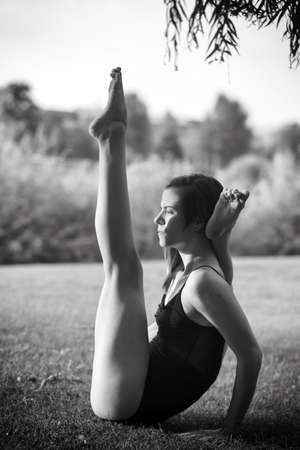 Young woman is practicing yoga in natureの写真素材