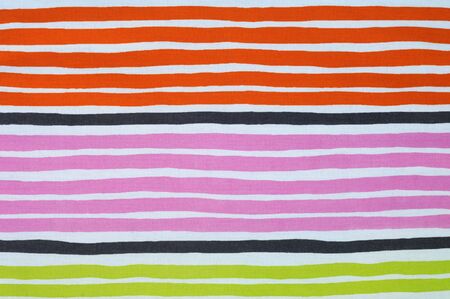 Bright striped tissue in orange, pink and green, excellent backgroundの写真素材