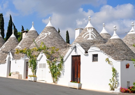 Trulli houses with painted symbols on the conical roofs in Alberobello, Italy, Pugliaのeditorial素材
