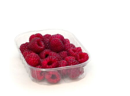Raspberries in plastic container on whiteの写真素材