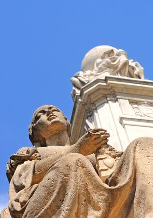 Stone statue of a praying woman at the Cervantes monument in Madrid, capital of Spain, Europe, shallow depth of fieldの写真素材