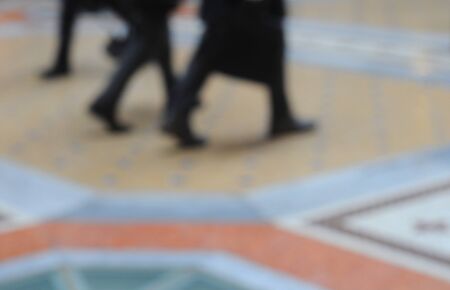 Intentionally blurred picture of people walking in the galleria vittorio emanuele in milan, italy, background blur, strong atmospheric imageの写真素材