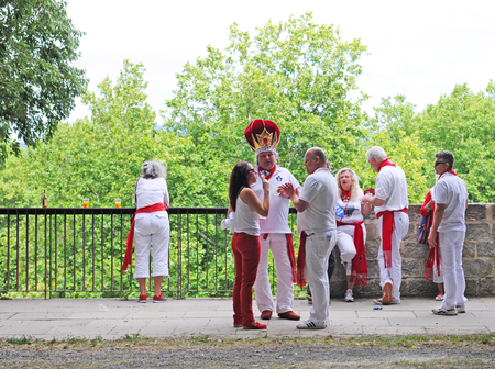 PAMPLONA, SPAIN - JULY 8, 2015: During the famous traditional annual feast of San Fermin, July 6 to 14, all inhabitants and most visitors are dressed in the city colours red and whiteのeditorial素材