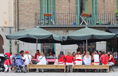 PAMPLONA, SPAIN - JULY 8, 2015: During the famous traditional annual feast of San Fermin, July 6 to 14, all inhabitants and most visitors are dressed in the city colours red and whiteのeditorial素材