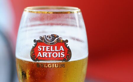 MILAN, ITALY - MAY 5, 2015: A glass of Stella Artois, a traditional Belgian pilsner beer since 1926, one of the prominent brands of Anheuser-Bush Inbevのeditorial素材