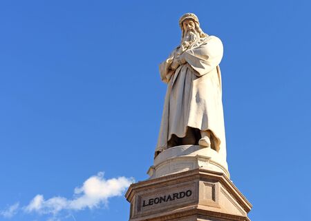 statue of leonardo da vinci against blue sky with a fluffly white cloud on e bright spring day in milan, italyの写真素材