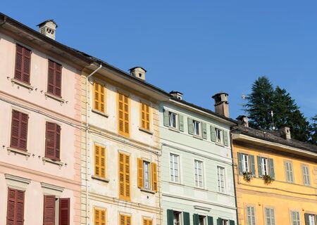 Typical colorful houses at the main square on a sunny evening in San Guillio di Orta, Italyの写真素材