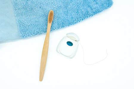 Bamboo toothbrush and floss, dental care, zero waste, healthy and sustainable lifestyle concept,...