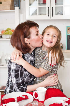 mother kisses and embraces the daughterの写真素材