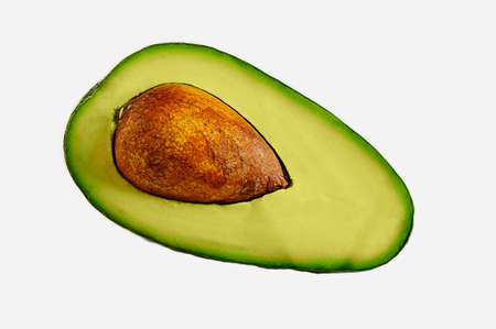 avocado half with pit isolated on white backgroundの写真素材