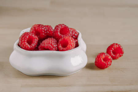 fresh raspberries in a small white bowl.