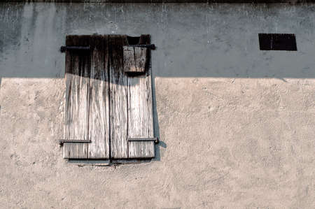 window with old wooden shutters on the concrete wallの写真素材