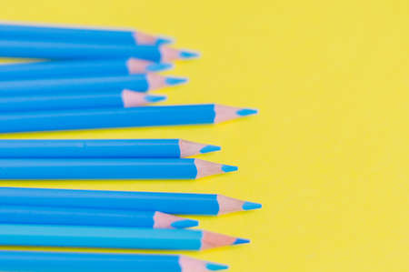 Sharpened blue pencils on a yellow background.School conceptの写真素材